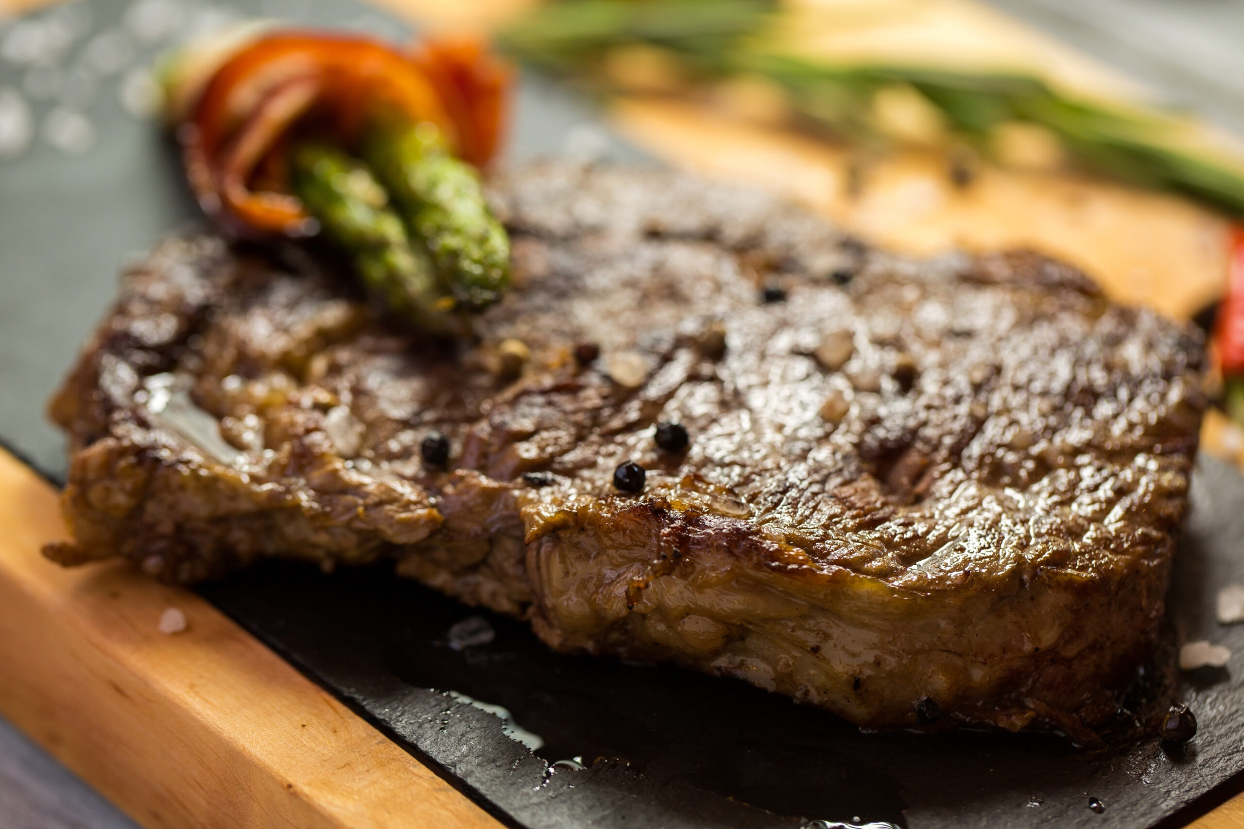 Brown steak on board.